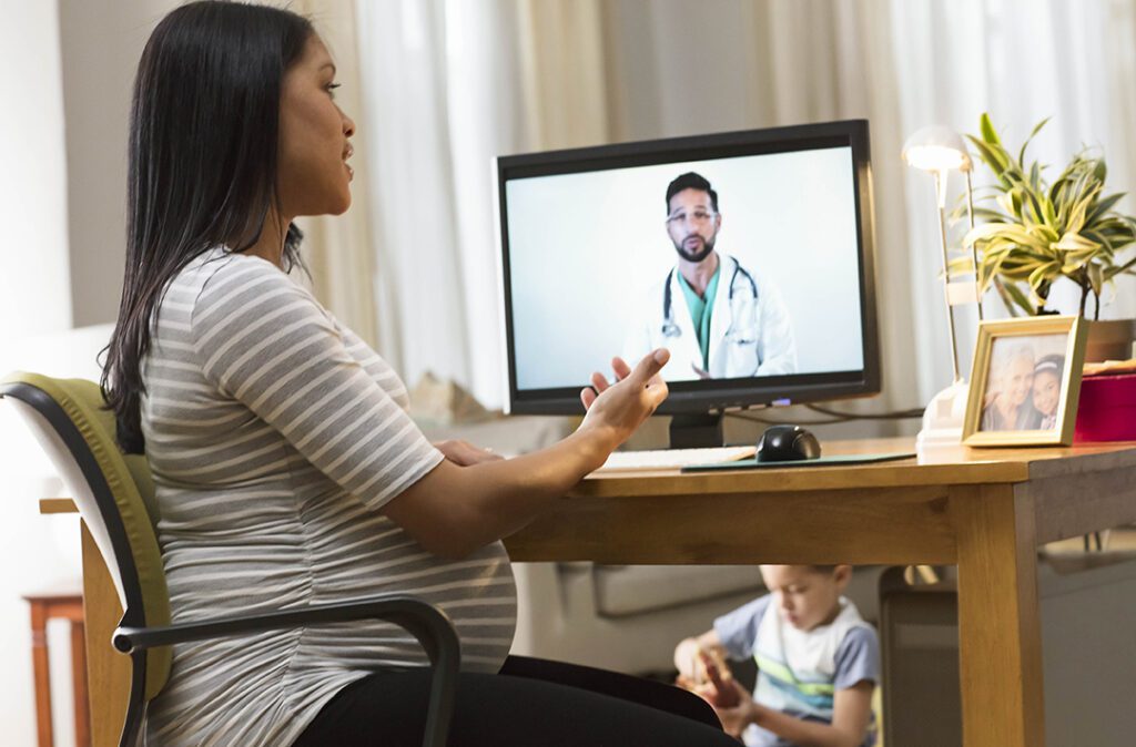 woman talking to doctor on computer